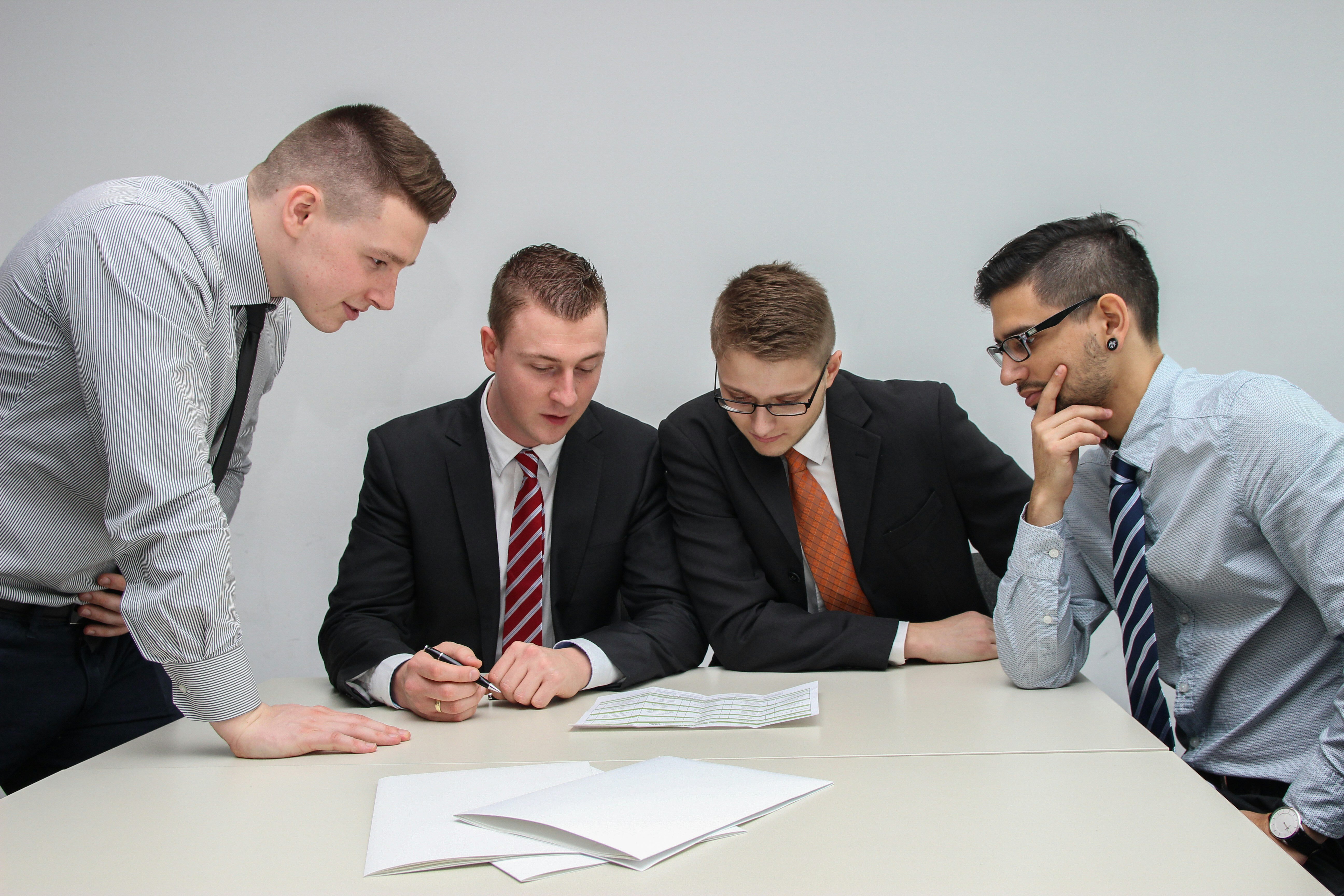 group of man in professional attire talking to each other